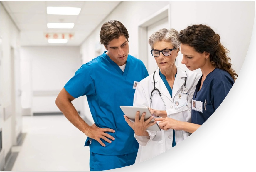 Medical professionals reviewing clinical information on a tablet
